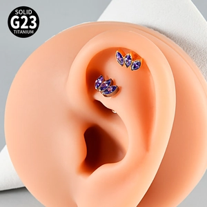 Detail view of G23 titanium labret studs with triple purple marquise stones on ear model