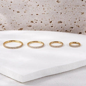 Detailed comparison of four sizes of gold titanium nose rings with clear zircon crystals