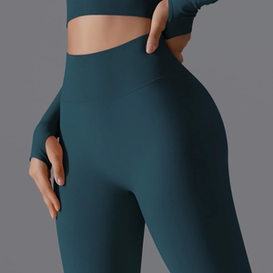 Detail view of high-waist seamless yoga leggings and long sleeve top with thumb holes