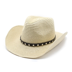Detail of beige straw cowboy hat featuring black faux leather band with silver metal rivets
