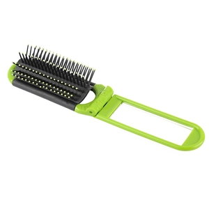 Detail view of green foldable hairbrush with integrated mirror and massage bristles