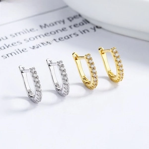 Detail of silver and gold U-shaped earrings with micro-pave cubic zirconia inlay