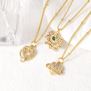 Three gold heart and star pendant necklaces with colorful zircon stones on white background