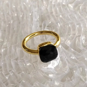 Detail of a gold stainless steel ring featuring a square emerald-cut black zircon stone