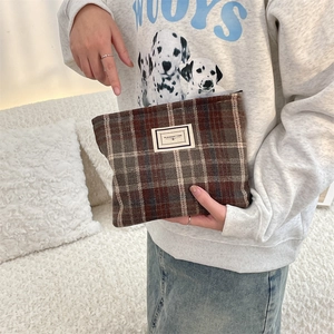 Close-up of vintage plaid wool pouch featuring a Pleasant Time label and sturdy zipper