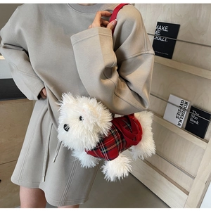 Detail of West Highland White Terrier plush bag with red plaid outfit and shoulder strap