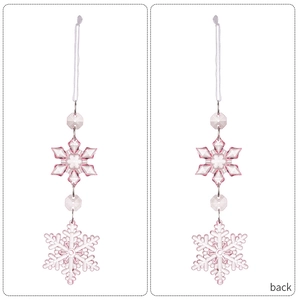 Macro detail of pink acrylic snowflake ornament with clear faceted beads and white cord