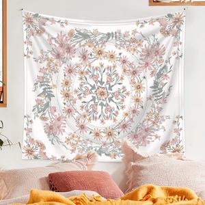 Bohemian floral mandala tapestry showing pink and orange patterns on a white wall