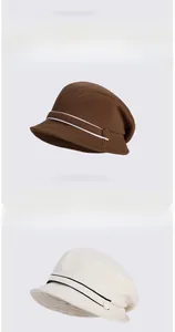 Detailed view of winter knitted plush bucket hats in brown and beige with button accents