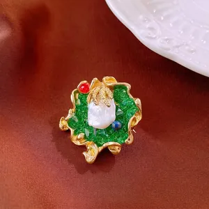 Vintage baroque pearl brooch with golden leaves and emerald resin on red silk