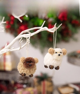 Detailed view of handmade plush sheep ornaments hanging on a white decorative branch