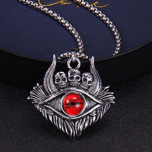 Gothic skull necklace with a large red devil eye pendant on a silver metal chain