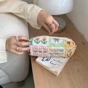 Detail view of a quilted floral patchwork pencil case showing high-quality zipper