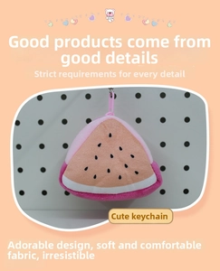 Detail of plush watermelon coin purse featuring soft fabric and pink plastic hook