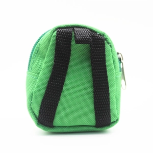 Close-up of a mini bright green canvas backpack coin purse with black straps and zipper