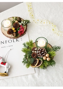 Detailed view of Christmas candle holder set with wood base pinecones and red berries