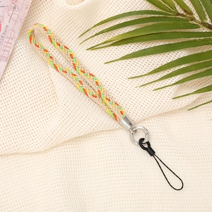 Detail of handmade woven wrist strap with colorful accents and silver metal ring