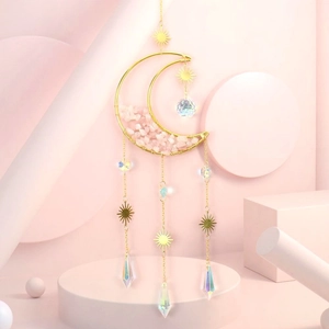 Detail of moon suncatcher with pink natural crystals and golden sun charm pendant