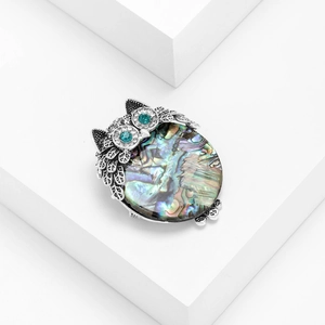 Exquisite owl brooch with rainbow abalone shell inlay and green gemstone eyes