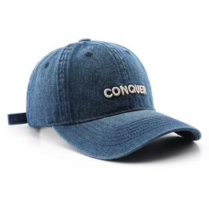 Retro dark blue denim baseball cap with white CONQUER embroidery and pre-curved brim