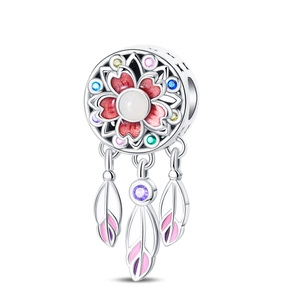 Macro view of dreamcatcher charm with floral enamel and colorful zircon stones