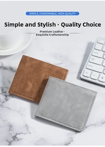 Flat lay of brown and grey slim matte leather bifold wallets on marble tabletop