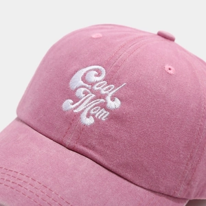 Close-up of Cool Mom embroidery on pink washed cotton baseball cap with fine stitching