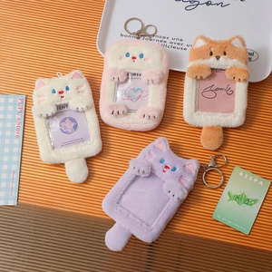 Detail of plush animal photo card holders with soft embroidery and metal keychains