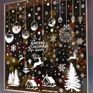 White Christmas window decals with snowflakes reindeer and holiday patterns on glass