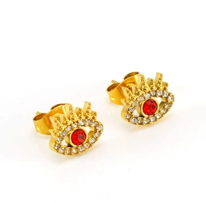 Macro view of gold evil eye stud earrings with red center stone and white zircon details