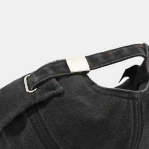 Close-up of adjustable silver metal buckle on washed cotton shark embroidery docker hat