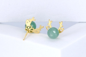 Macro shot of S925 silver elk antler earrings with green beads and white cubic zirconia