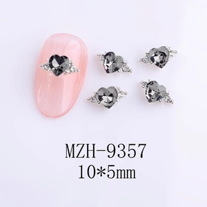 Detail of 10x5mm silver heart nail charms with dark grey rhinestones on pink nails