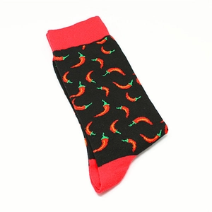 Close-up of black cotton socks featuring red chili pepper patterns and elastic cuffs