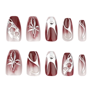 Short ballerina press-on nails with red gradient, silver flame patterns and 3D metal studs