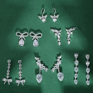 Luxury S925 sterling silver stud earrings with bow and teardrop zircon on green velvet