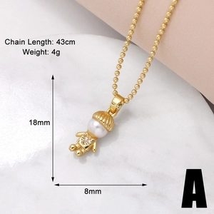 Golden boy girl necklace with pearl head and dimensions 18x8mm displayed on marble