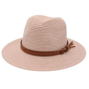 Close-up of pink Fedora straw hat with dark brown faux leather band and gold buckle details