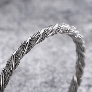 Vintage silver woven steel wire bangle with detailed wolf head texture for men