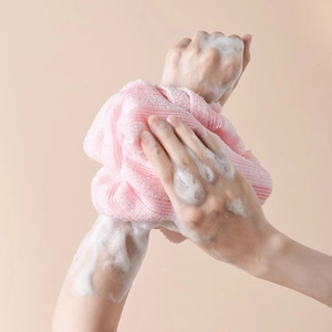 Pink exfoliating back scrubber cloth with rich lather for gentle body cleansing