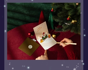 Detail of 3D pop-up Christmas card with Santa and envelope in festive holiday setting
