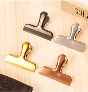 Detailed view of T-shaped stainless steel food clips in four premium metallic finishes
