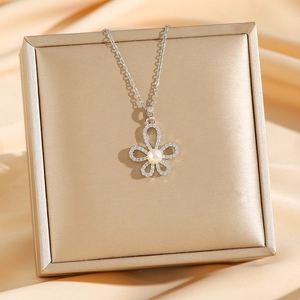 Elegant five-petal flower pearl necklace with sparkling crystals on a silk backdrop