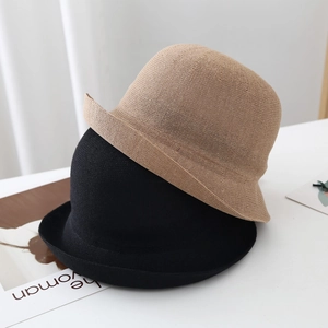 Close-up of the breathable paper fiber woven texture on black and khaki bucket hats
