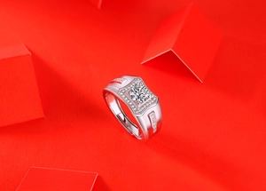 Macro shot of silver moissanite ring with square setting on a vibrant red background