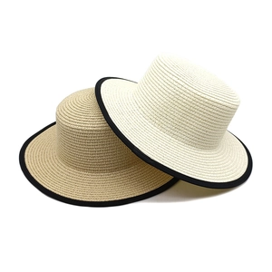 Classic French dome straw hats in beige and white with black ribbon trim and flat brim