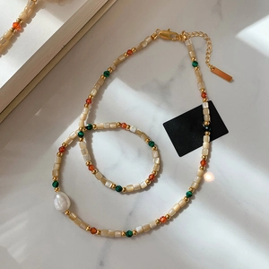 Detail of bohemian layered bracelet with freshwater baroque pearls and gold beads