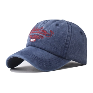 Detail of vintage navy blue New York City embroidery on washed cotton baseball cap