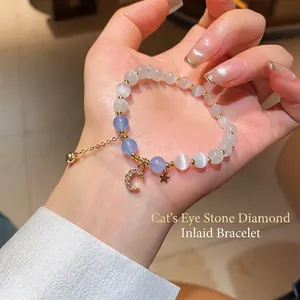 Elegant cat's eye stone bracelet with moon star pendants and gold accents on wrist