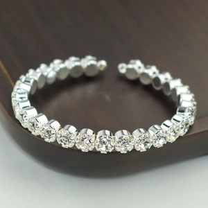 Macro shot of silver adjustable open bangle with sparkling cubic zirconia crystals